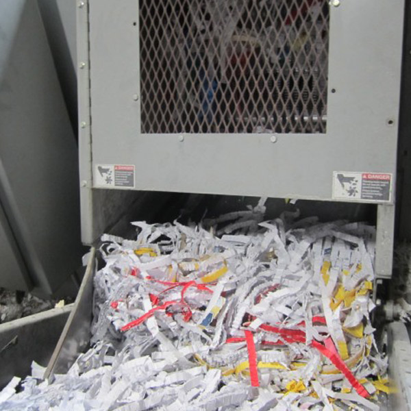strips of papers coming out of paper shredder