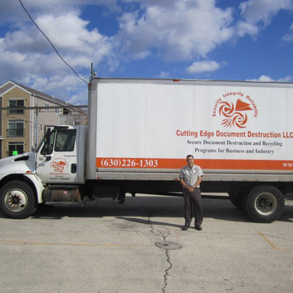 employee standing in front of cutting edge work truck